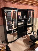 Front view of the 3-piece vintage wall unit showing the glass-front cabinets and shelving.