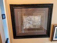 Photo of the framed art print 'Femme Allongee' by Dan Bennion showing the full front with the artwork of a reclining female figure in line drawing style.