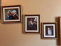 All three framed paintings hung on wall