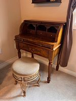 Photo of Tuzy Muzy wooden roll top desk with carved floral details and matching stool.