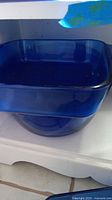 Square cobalt blue glass baking dish with smooth edges and no visible chips or cracks