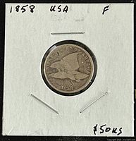 Obverse side of the 1858 Flying Eagle cent showing the eagle design and date with grading and price annotation.