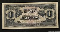 Front side of 1942 Japanese Government issued One Dollar banknote showing detailed border and central text with fruit basket illustration.
