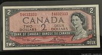 Front face of 1954 Canadian two dollar banknote showing Queen Elizabeth II portrait, denomination, serial number, and signatures.