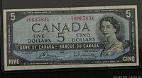 Front view of 1954 Canadian five dollar banknote showing portrait of Queen Elizabeth II and denomination markings.