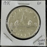 Obverse of 1955 Canadian silver dollar showing two men in a canoe beneath the word CANADA and the date 1955, mounted in a white protective holder labeled EF condition and silver .8000