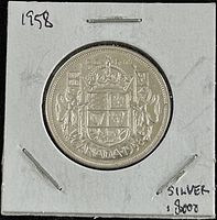 Obverse photo showing the Canadian coat of arms with denomination and date '1958'.