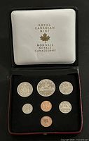 Black Royal Canadian Mint presentation case with seven Canadian coins from 1972 neatly arranged inside.