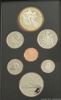 Top view of the coins in the case showing 1983 double dollar coin and other coins arranged with various Canadian designs.