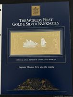 Blue presentation folder for the gold and silver banknote with the title and ship illustration