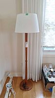 Full view of floor lamp showing overall height, wood finish, shade and base