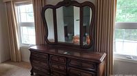 Front view of the full dresser with trifold mirror showing drawer layout and decorative woodwork.