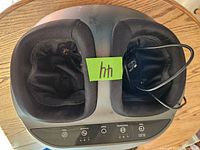 Top view of the Renpho foot massager showing padded foot compartments and power cord.