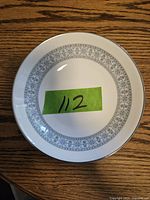 Top view of a single Wedgwood Counterpoint soup bowl showing the blue floral pattern on the inner rim and silver/gray band on the outer rim.