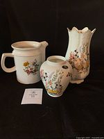 Group view of two Aynsley vases and stoneware jug
