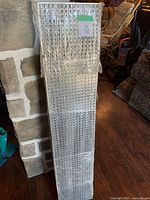 Stack of five plastic egg-crate style fluorescent fixture covers wrapped in original plastic