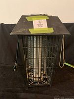 Front view of square black metal bug zapper showing cage and internal light