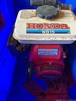 Top view showing HONDA WB15 decal on fuel tank, pump housing and engine components