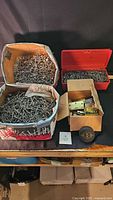 Overall lot showing boxes of nails, hardware box and hockey puck