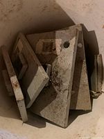 Bucket containing multiple steel jackpost plate covers