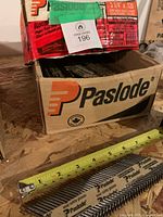 Open Paslode box showing paper tape collated nails