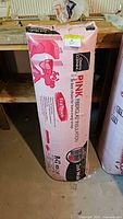 Full view of sealed Owens Corning PINK insulation bag standing upright