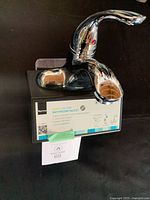 Front view of Taymor chrome faucet on box showing product label