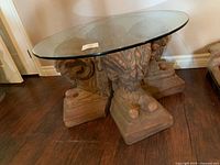 full view of coffee table showing glass top and ram head base