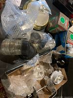 Multiple light fixtures and hardware on table