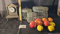 Entire lot showing clock, three baskets, nine pears