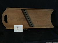 Full view of wooden cabbage cutter with blade and handle