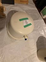 Top view of white Kemflo RO storage tank showing outlet fitting and lot sticker