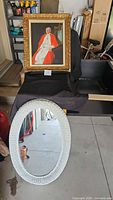 Full view of both items: wicker mirror and framed painting