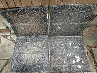 Four antique Victorian embossed metal tiles shown laid out, displaying the full set with detailed floral and scroll embossing.