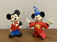 Photo of two hollow porcelain Mickey Mouse figurines: classic Mickey and wizard Mickey
