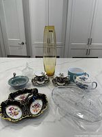 Full lot overview showing all items on a white countertop, including cups, saucers, divided dishes, small bowls, and tall vase.