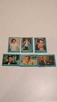 Six vintage Happy Days trading cards laid out on a surface, showing front images with characters and quotes.