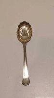 Full view of the sterling silver christening spoon showing the entire length and shape.