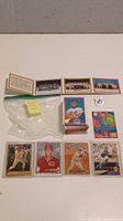 Photo of assorted baseball cards laid out with individually visible players and group photo strips.