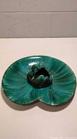 Top and angle view of Blue Mountain Pottery swan console bowl, showing the green and blue drip glaze and swan centerpiece on lily pad shaped bowl