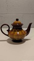 Side view of vintage BMP Brown Mountain Pottery coffee pot teapot showing shape, handle, spout and lid.