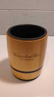 Front view of the wooden Canadian Club Reserve ice bucket showing the cask shape, wood material, and printed logo.