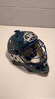Left side angle view of the blue Koho street hockey goalie mask showing the SR Revolution logo and number 29 on chin.