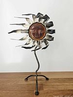 Full view of sun face tealight holder on stand