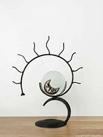 Full view of sunburst metal tealight holder showing design and size