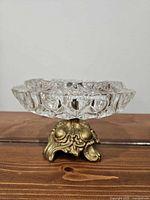 Side view showing cut glass pattern and ornate metal base
