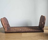 Book rack partially extended with both carved elephant ends upright