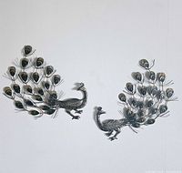 Both metal peacock wall art pieces arranged to show overall design and mirror image tails