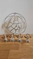 Front view of four angel napkin rings and round angel suncatcher