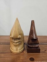 Light and dark wooden eyeglass holders side by side